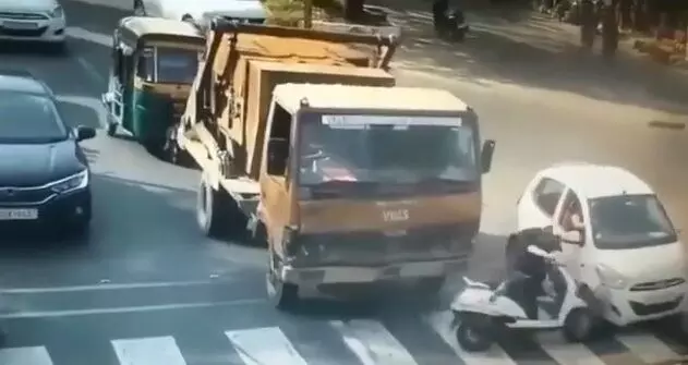 Vadodara city police shared video of girl crashed into a moving car at a traffic signal
