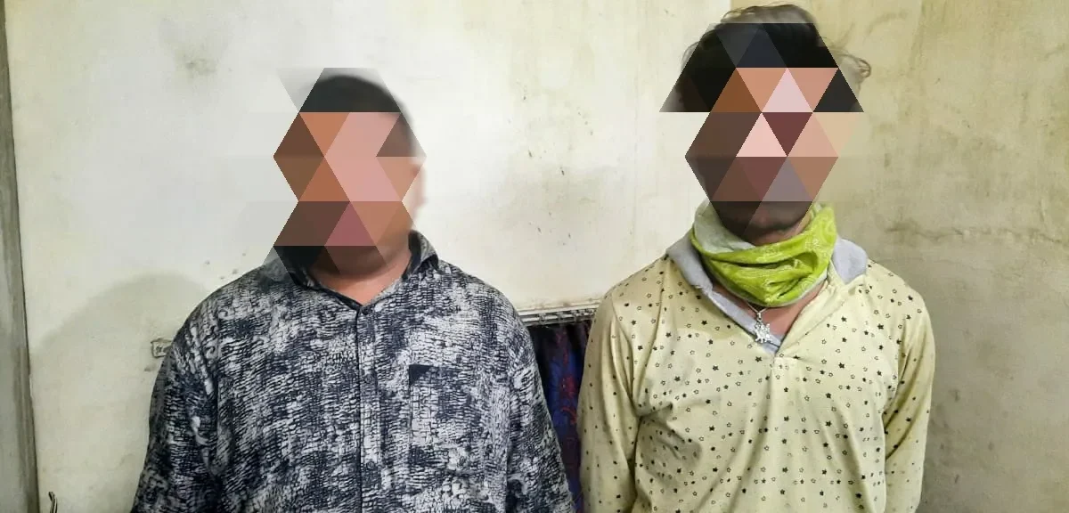 Two persons were caught with liquor hidden in a hidden pocket of a vehicle
