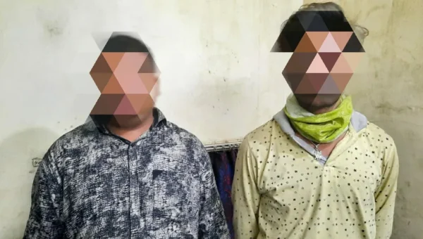 Two persons were caught with liquor hidden in a hidden pocket of a vehicle