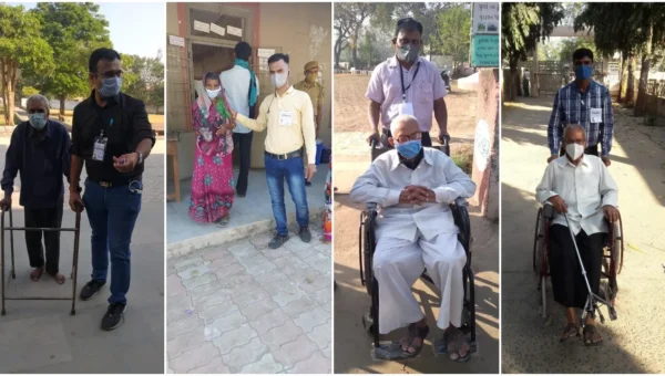 Volunteers help elderly and other voters in casting their votes in Vadodara