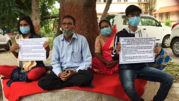 Student with family sit on fast outside Vadodara DEO office