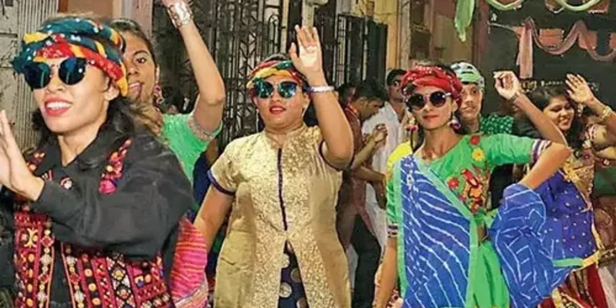 Garba enthusiasts in Vadodara play garba with umbrellas amid showers