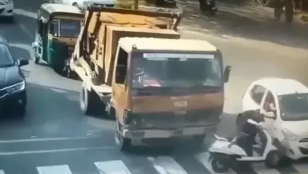 Vadodara city police shared video of girl crashed into a moving car at a traffic signal