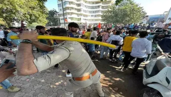 In Rajkot, Gujarat, a mob vandalises a police truck and shops